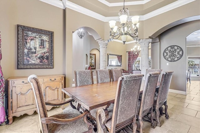 dining room featuring arched walkways, a chandelier, crown molding, and decorative columns