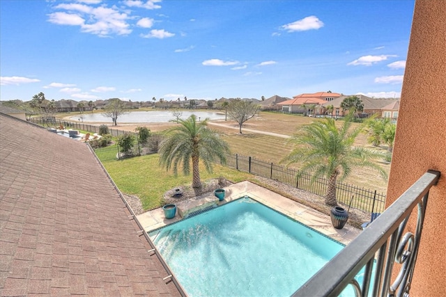 view of pool with a lawn, a water view, a fenced backyard, and a fenced in pool