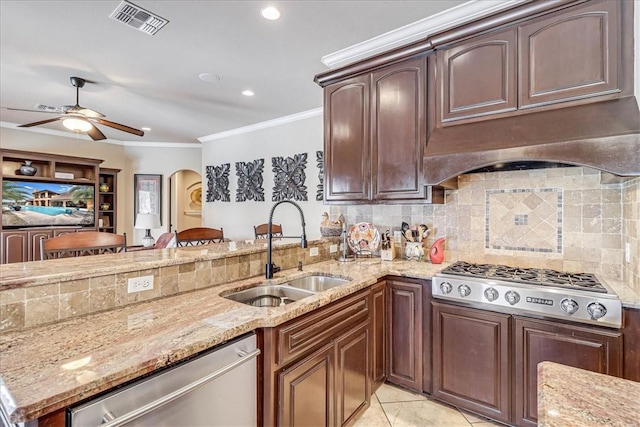 kitchen with visible vents, crown molding, arched walkways, stainless steel appliances, and a sink