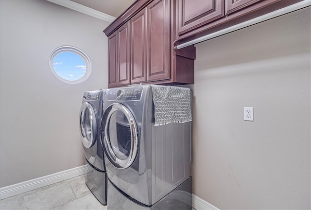 washroom featuring washer and dryer, baseboards, cabinet space, and crown molding