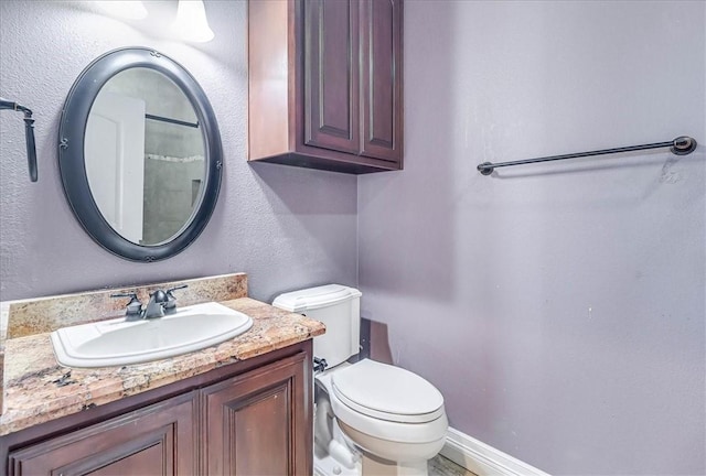 bathroom featuring toilet and vanity