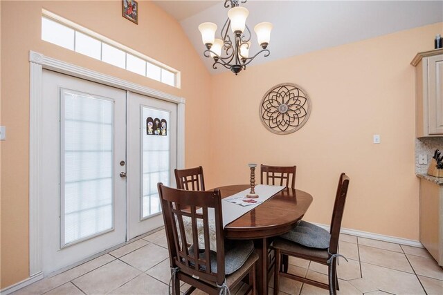 dining space featuring light tile patterned floors, baseboards, a chandelier, and french doors