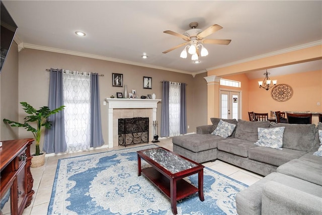 living area featuring a tiled fireplace, french doors, ornamental molding, and light tile patterned flooring