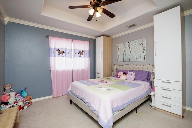 carpeted bedroom featuring baseboards, visible vents, a raised ceiling, and ornamental molding