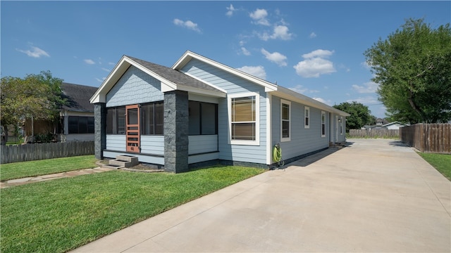 view of front of house featuring a front lawn and a sunroom