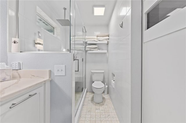 bathroom with vanity, toilet, and walk in shower