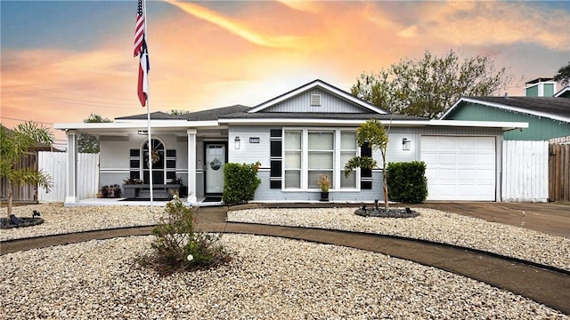 view of front of home featuring a porch and a garage