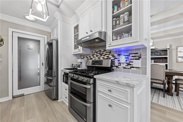 kitchen featuring light stone countertops, light wood-type flooring, white cabinetry, and stainless steel appliances