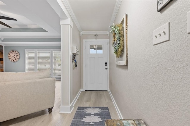 entryway with ceiling fan, light wood-type flooring, and crown molding