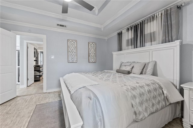 bedroom featuring light hardwood / wood-style flooring, ceiling fan, and crown molding