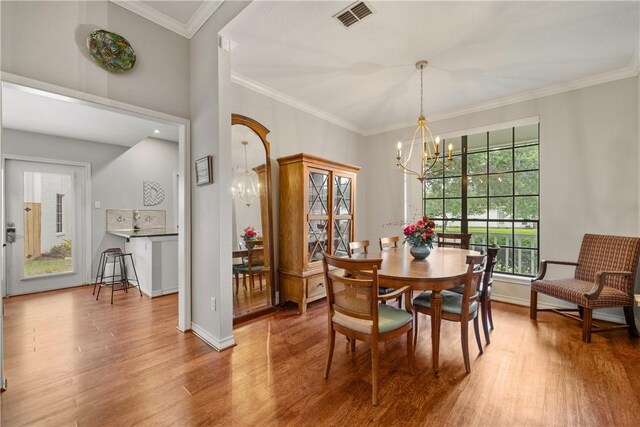 4442 Lake Superior Dr, Corpus Christi, TX 78413 - dining space featuring wood finished floors, a chandelier, ornamental molding, and baseboards