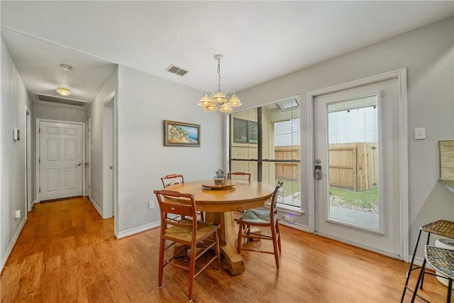 4442 Lake Superior Dr, Corpus Christi, TX 78413 - dining area featuring light wood-style flooring, plenty of natural light, a chandelier, and baseboards