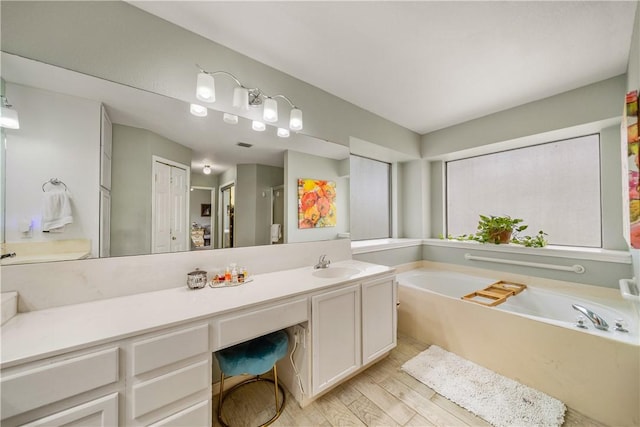 4442 Lake Superior Dr, Corpus Christi, TX 78413 - full bathroom with wood finished floors, a garden tub, vanity, and a stall shower