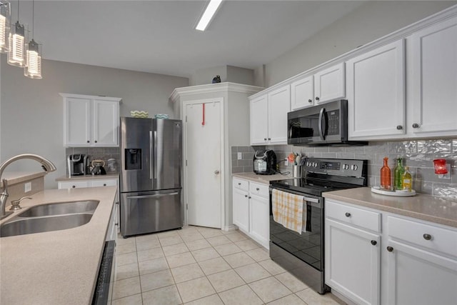 6517 Macarena Dr, Corpus Christi, TX 78414 - kitchen featuring a sink, light tile patterned flooring, stainless steel appliances, white cabinets, and backsplash