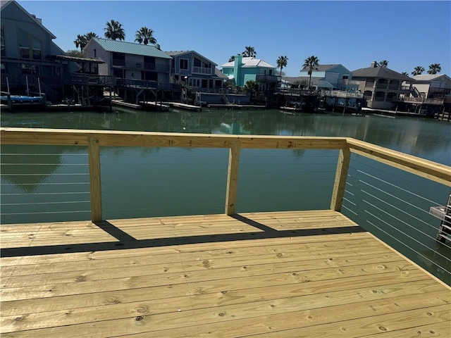 view of dock with a water view and a residential view