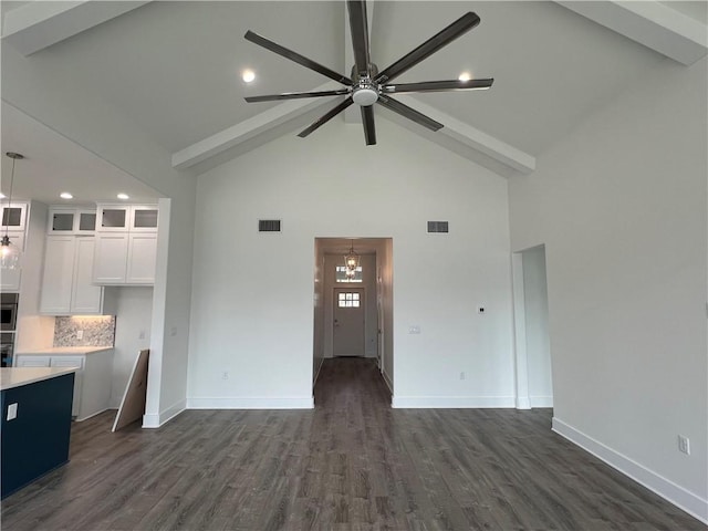 unfurnished living room featuring dark wood-style floors, ceiling fan with notable chandelier, visible vents, and baseboards