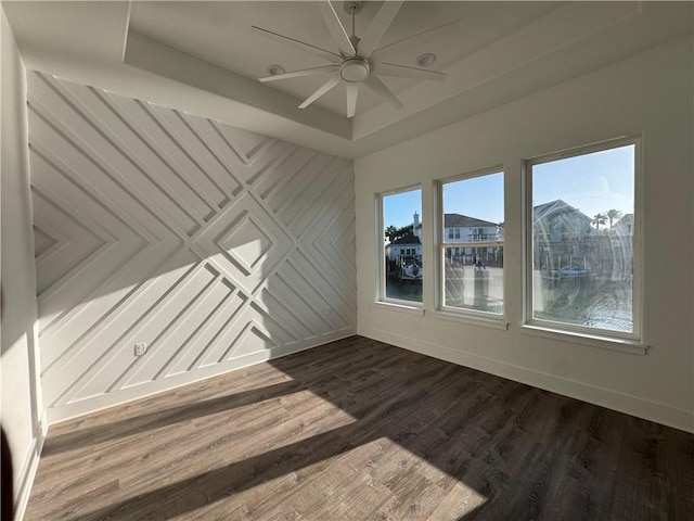 13741 Tajamar St, Corpus Christi, TX 78418 - empty room featuring dark wood-type flooring, a ceiling fan, and a tray ceiling