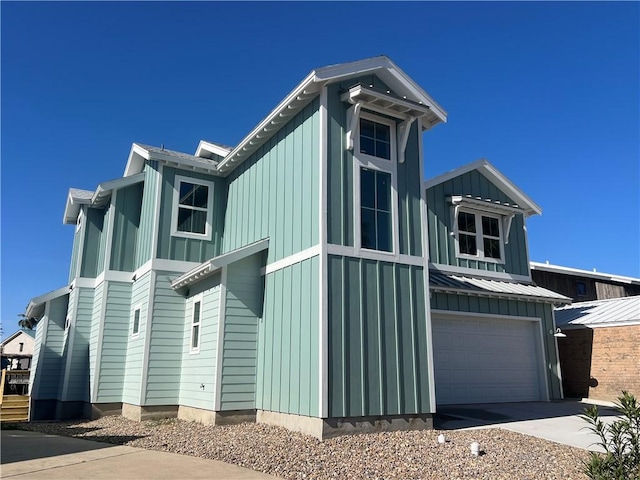 view of property exterior featuring a garage, board and batten siding, and driveway