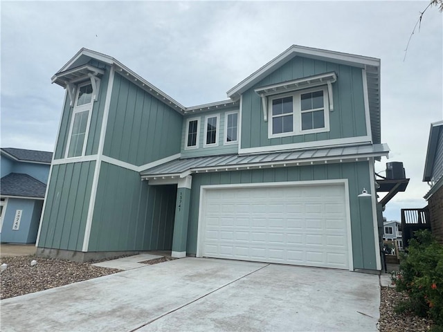 13741 Tajamar St, Corpus Christi, TX 78418 - view of front facade with a standing seam roof, an attached garage, a metal roof, and concrete driveway