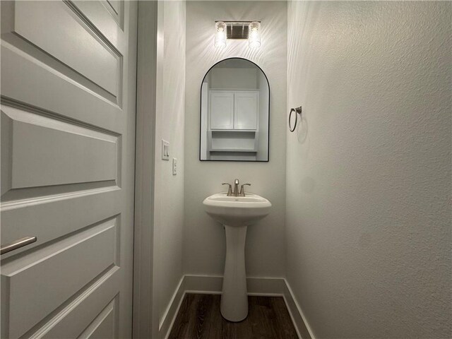 13741 Tajamar St, Corpus Christi, TX 78418 - bathroom featuring baseboards and wood finished floors