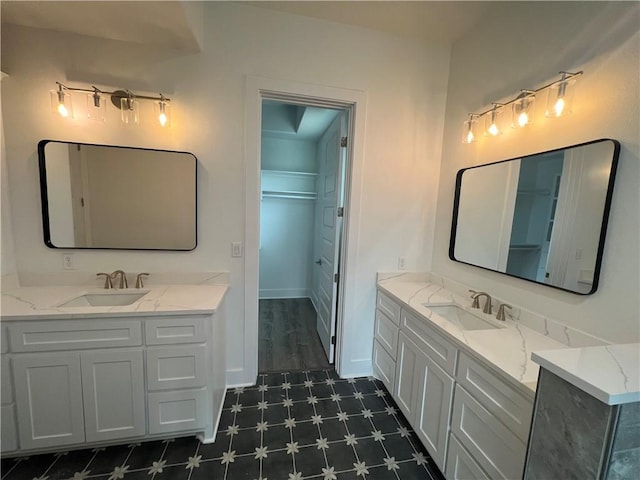 13741 Tajamar St, Corpus Christi, TX 78418 - bathroom with two vanities, tile patterned floors, and a spacious closet