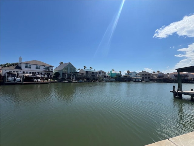 dock area with a water view and a residential view