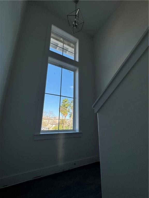 details with a notable chandelier and baseboards