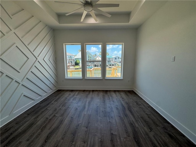 13741 Tajamar St, Corpus Christi, TX 78418 - unfurnished room featuring ceiling fan, a raised ceiling, and dark wood finished floors