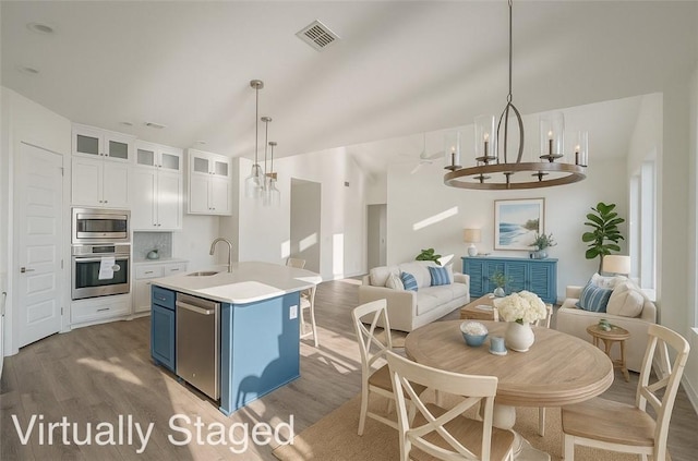 13741 Tajamar St, Corpus Christi, TX 78418 - kitchen with stainless steel appliances, open floor plan, a chandelier, light wood-style floors, and vaulted ceiling