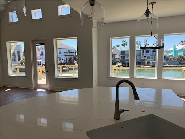 interior space with a healthy amount of sunlight, wood finished floors, and a sink