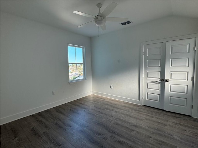 unfurnished bedroom featuring visible vents, a ceiling fan, dark wood-type flooring, and baseboards