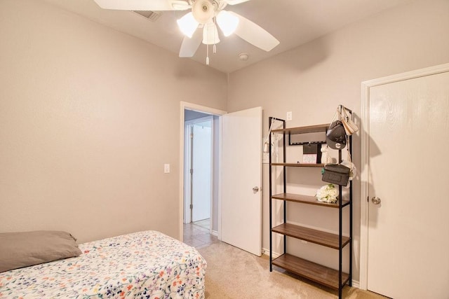 bedroom with light colored carpet and ceiling fan