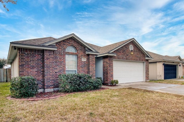 ranch-style home featuring a garage and a front lawn