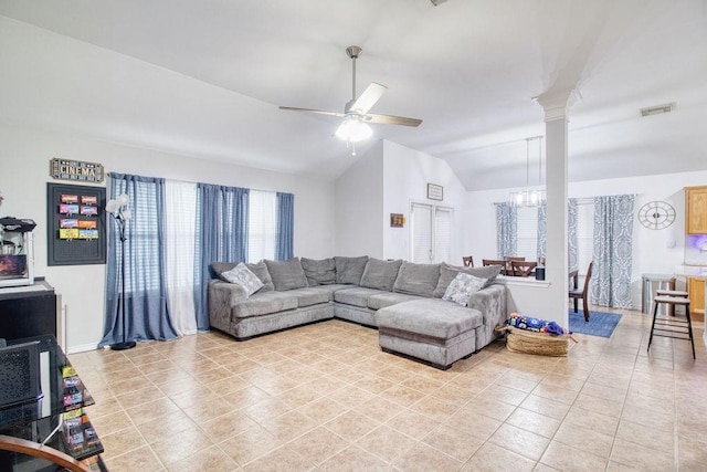 tiled living room featuring vaulted ceiling, ceiling fan, and ornate columns