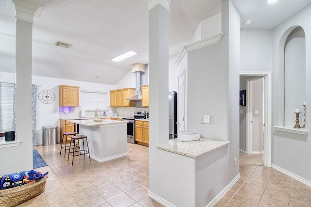 kitchen with a breakfast bar area, stainless steel range with electric cooktop, light tile patterned floors, kitchen peninsula, and light stone countertops