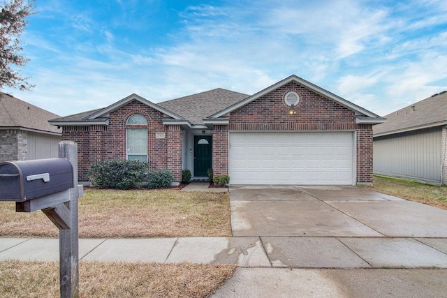 view of front of home featuring a garage and a front yard