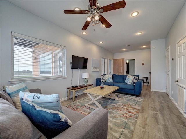 living room featuring ceiling fan and light wood-type flooring