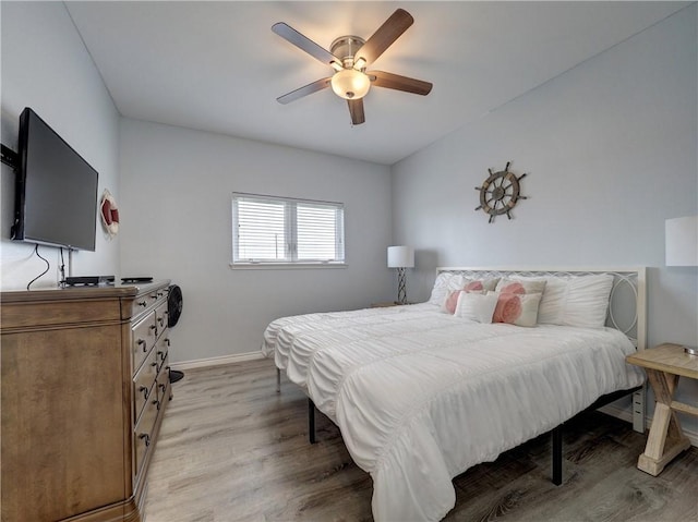 bedroom with ceiling fan and light hardwood / wood-style flooring