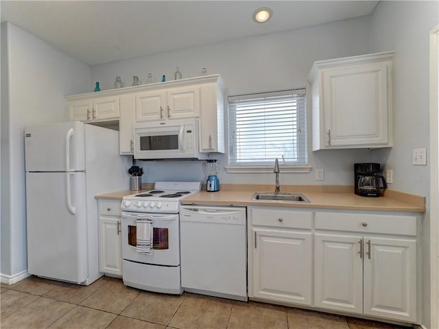 kitchen featuring sink, white appliances, white cabinets, and light tile patterned flooring