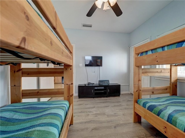 bedroom with ceiling fan and light hardwood / wood-style floors