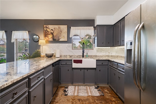 kitchen with sink, gray cabinets, appliances with stainless steel finishes, backsplash, and light stone countertops