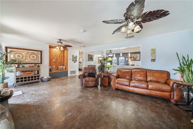 living room with ceiling fan and concrete flooring