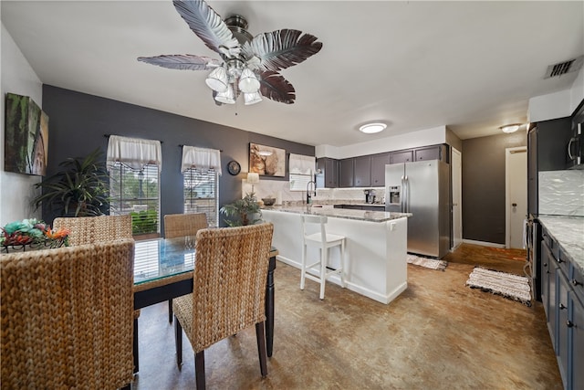 dining area featuring sink and ceiling fan