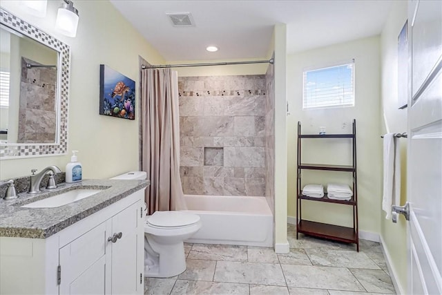 full bathroom featuring shower / bath combo with shower curtain, vanity, and toilet