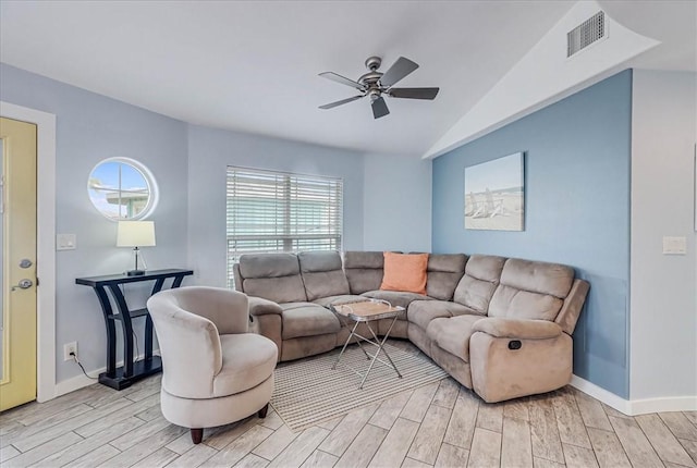 living room featuring ceiling fan, lofted ceiling, and light wood-type flooring