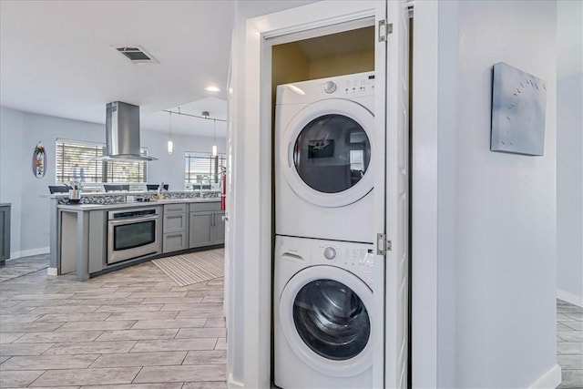 washroom with stacked washer and dryer