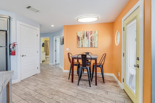 dining space with light hardwood / wood-style flooring