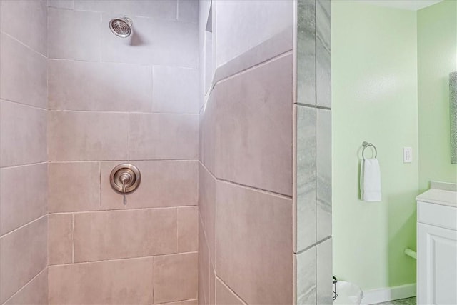 bathroom featuring vanity and a tile shower