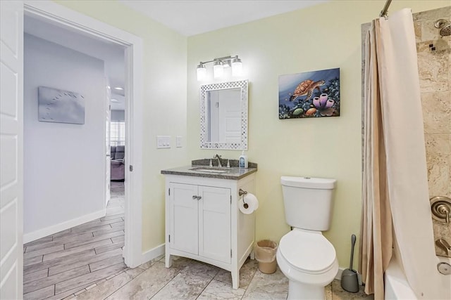 full bathroom featuring hardwood / wood-style floors, vanity, shower / tub combo, and toilet