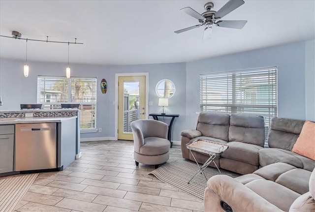 living room featuring rail lighting and ceiling fan